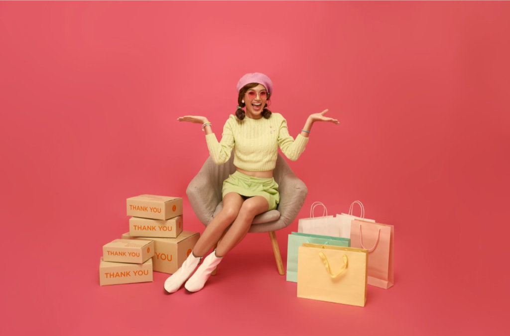 Person with shopping bags on pink background